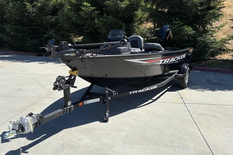 Slide: The Image of 2026 Tracker Super Guide V-16 SC boat on trailer, parked outdoors. - 9