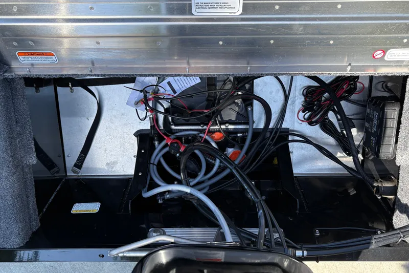 Slide: The Image of 2026 Tracker Super Guide V-16 SC boat wiring and battery compartment. - 28