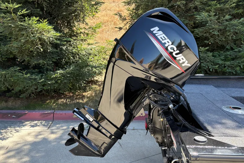 Slide: The Image of Outboard motor on 2026 Tracker Super Guide V-16 SC boat, parked near greenery. - 27