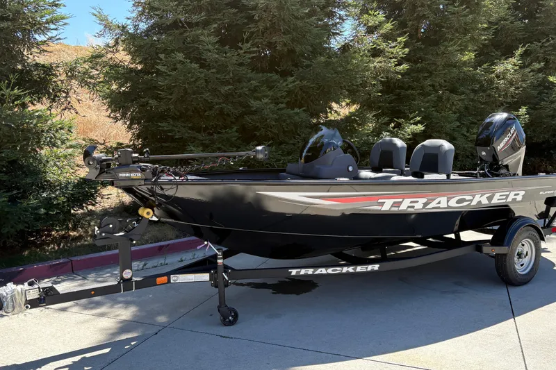 Slide: The Image of 2026 Tracker Super Guide V-16 SC boat on trailer, parked outdoors. - 11