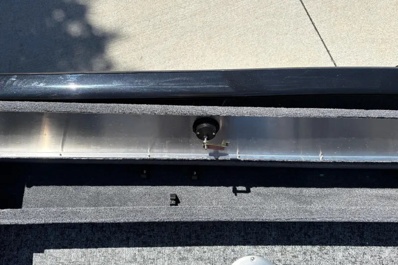 Slide: The Image of Interior view of a 2026 Tracker Super Guide V-16 SC boat, showcasing storage compartment details. - 25
