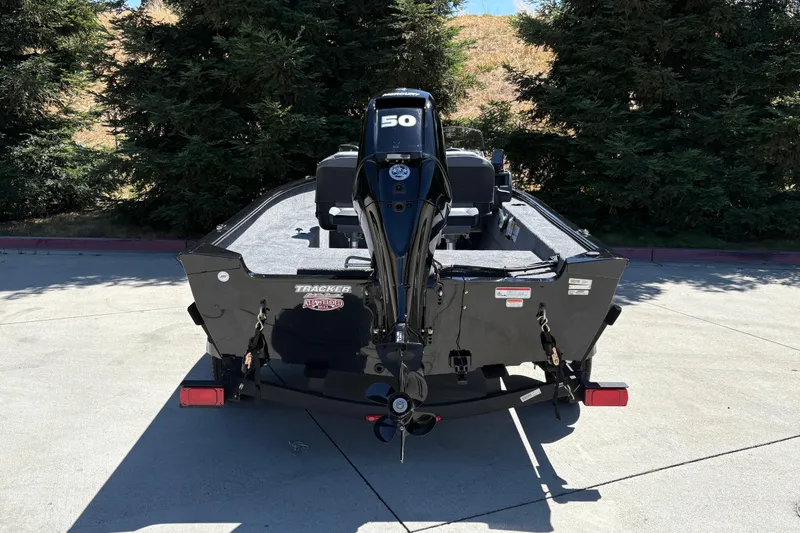Slide: The Image of 2026 Tracker Super Guide V-16 SC boat with a 50 HP motor, parked outdoors. - 8