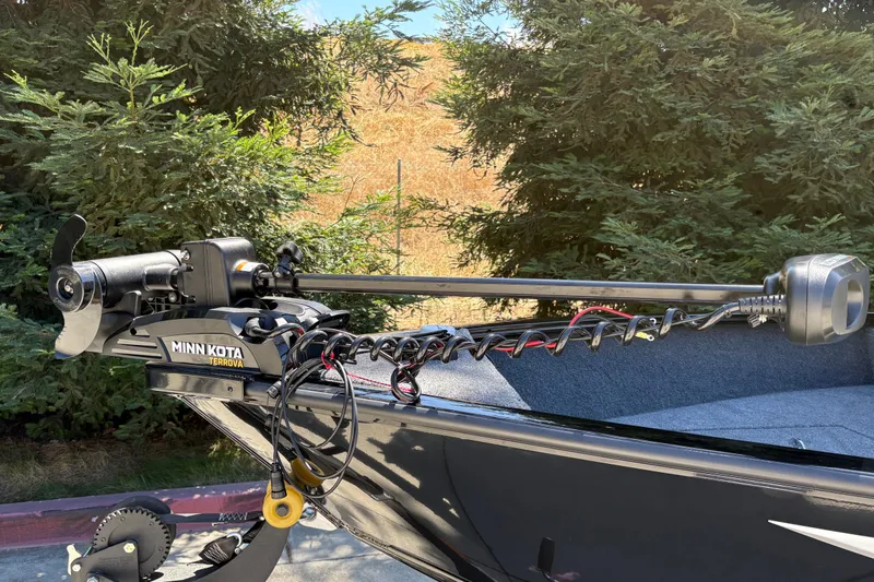 Slide: The Image of Minn Kota Terrova motor on 2026 Tracker Super Guide V-16 SC boat, surrounded by trees. - 13