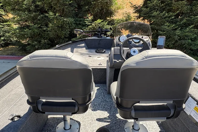 Slide: The Image of 2026 Tracker Super Guide V-16 SC boat interior with dual seats and steering console. - 17