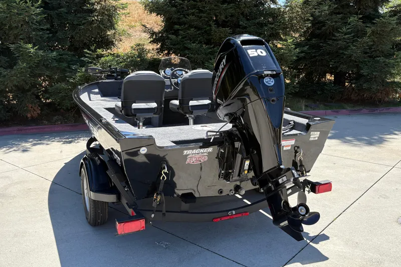 Slide: The Image of 2026 Tracker Super Guide V-16 SC boat with Mercury 50 engine, parked outdoors. - 7