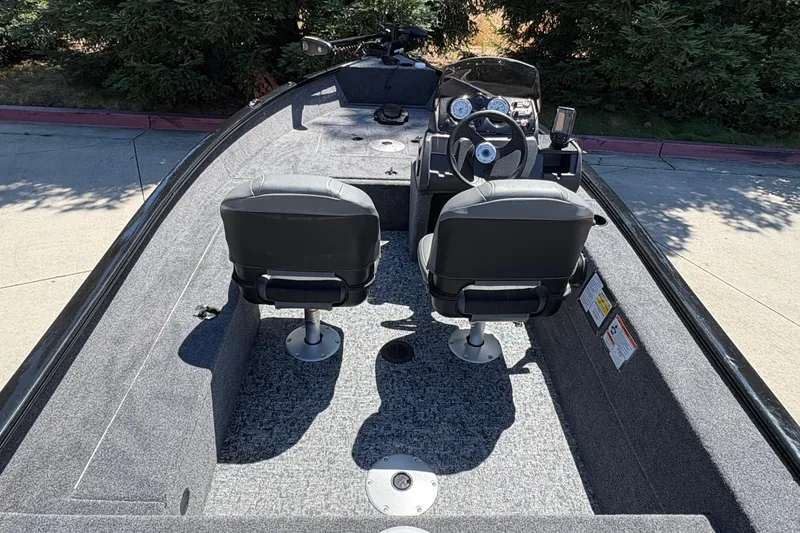 Slide: The Image of 2026 Tracker Super Guide V-16 SC boat interior with dual seats and steering console. - 18