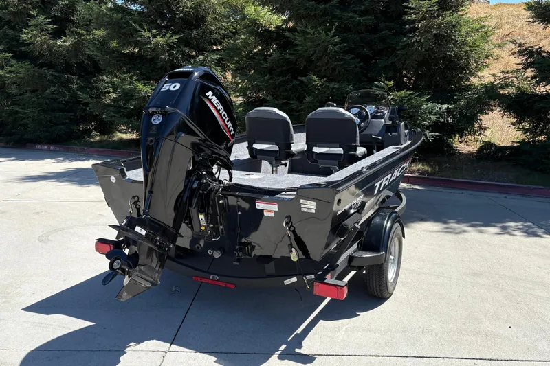 Slide: The Image of 2026 Tracker Super Guide V-16 SC boat with Mercury 50 engine, parked outdoors. - 3
