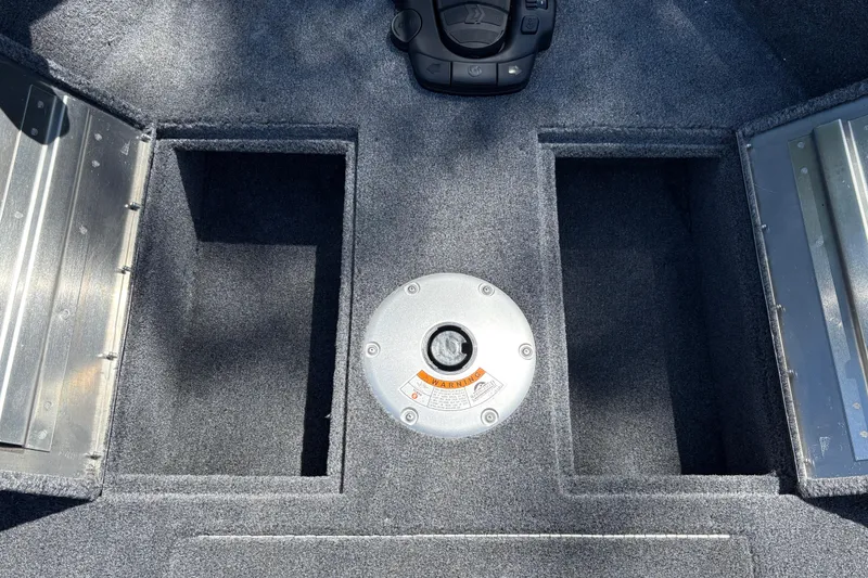 Slide: The Image of Interior view of 2026 Tracker Super Guide V-16 SC boat, featuring carpeted storage compartments. - 23