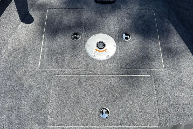 Slide: The Image of Carpeted deck of 2026 Tracker Super Guide V-16 SC boat with storage compartments. - 30