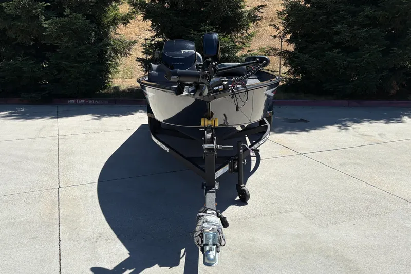 Slide: The Image of 2026 Tracker Super Guide V-16 SC boat on trailer, parked outdoors. - 6