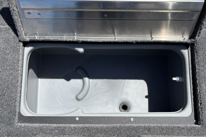 Slide: The Image of Open storage compartment in 2026 Tracker Super Guide V-16 SC boat. - 26