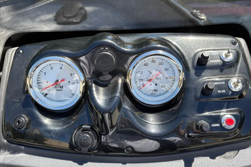 Slide: The Image of Dashboard of 2026 Tracker Super Guide V-16 SC with RPM and speed gauges. - 20