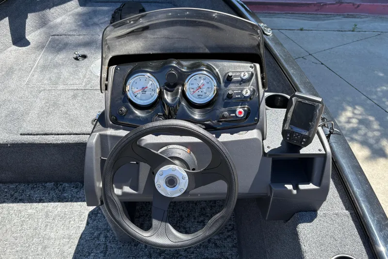 Slide: The Image of Steering console of 2026 Tracker Super Guide V-16 SC boat with gauges and controls. - 19