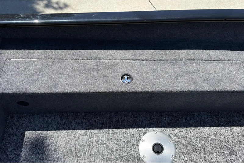 Slide: The Image of Interior view of 2026 Tracker Super Guide V-16 SC boat, featuring carpeted storage compartment. - 24