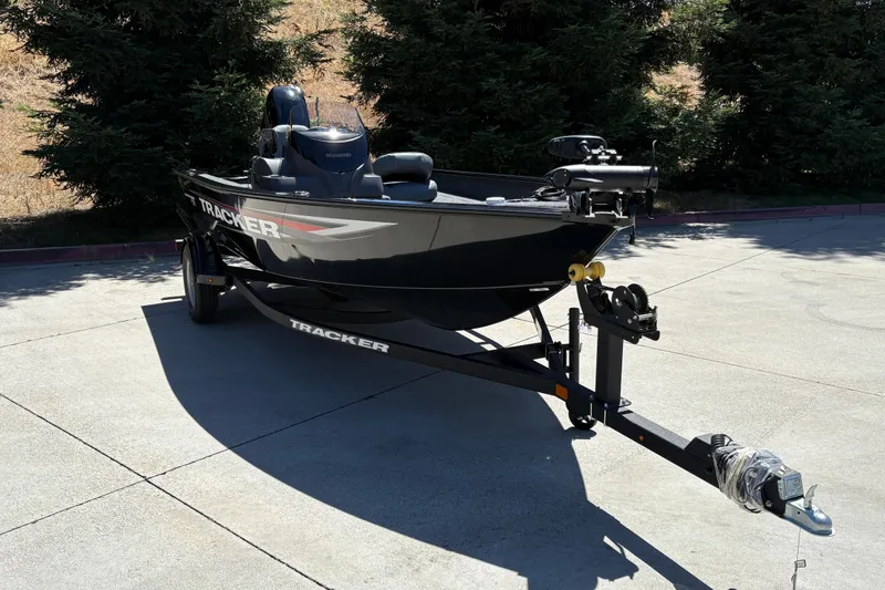 Slide: The Image of 2026 Tracker Super Guide V-16 SC boat on trailer, parked outdoors. - 10