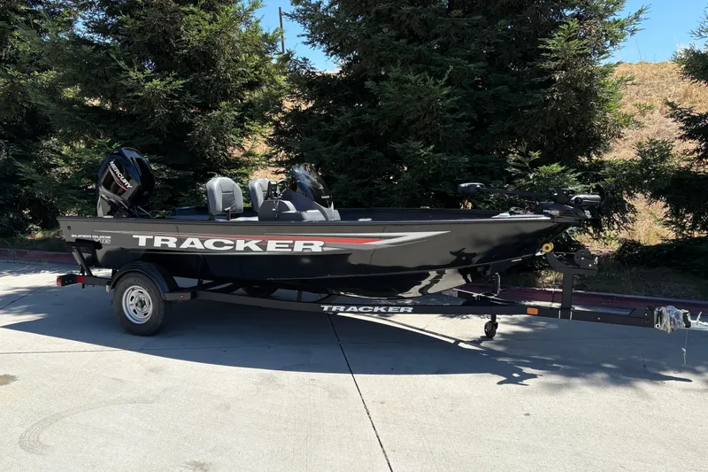 Slide: The Image of 2026 Tracker Super Guide V-16 SC boat on trailer, parked outdoors. - 4
