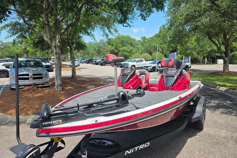 Slide: The Image of 2026 Nitro Z19 XL boat with Minn Kota trolling motor in a parking lot. - 1