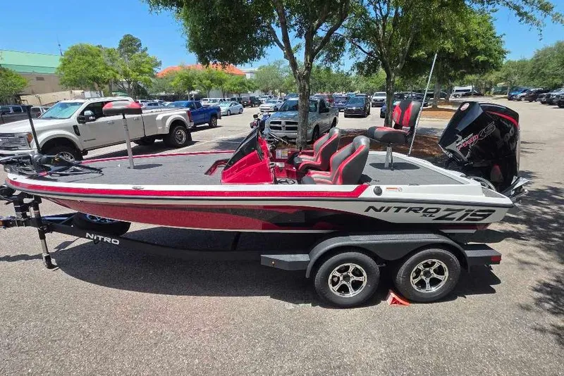 Slide: The Image of 2026 Nitro Z19 XL boat in parking lot, featuring sleek design and modern features. - 2