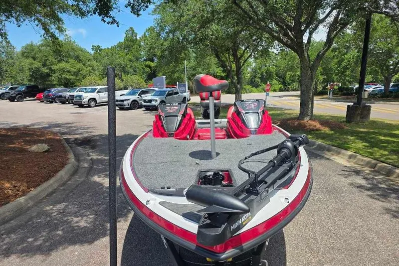 Slide: The Image of 2026 Nitro Z19 XL boat parked in a lot, surrounded by trees and vehicles. - 4