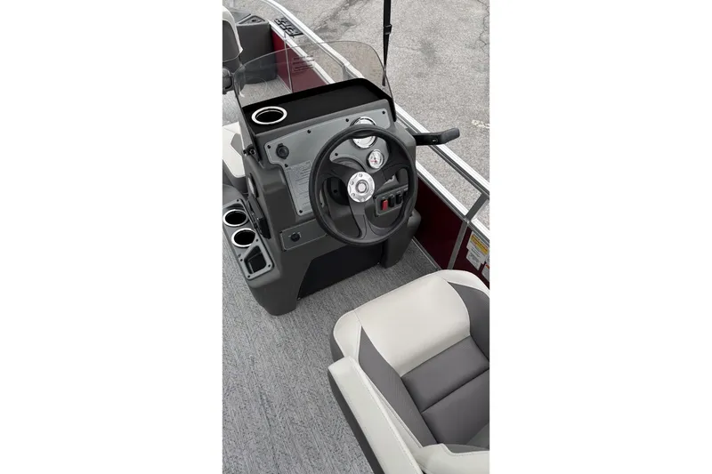 Slide: The Image of 2026 Sun Tracker Bass Buggy 18 DLX boat console with steering wheel and seating. - 4