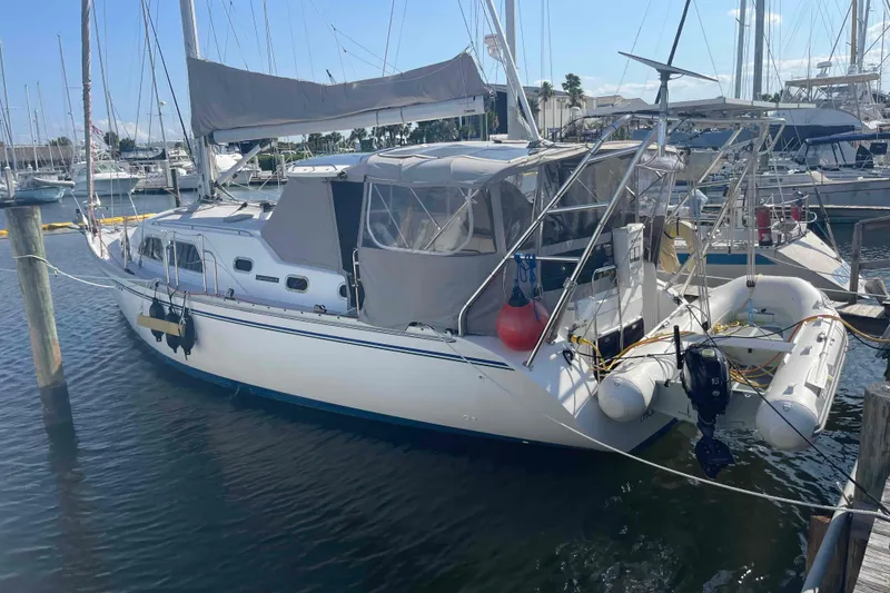 The Image of Sailboat Catalina Morgan 440, 2013 model, docked at marina with inflatable dinghy attached. - 0