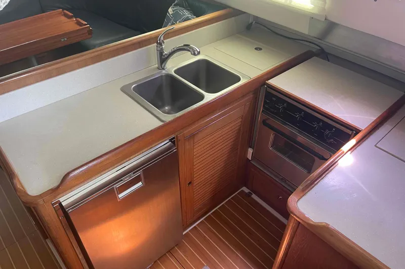 Slide: The Image of Galley kitchen in 2013 Catalina Morgan 440 yacht with sink, stove, and fridge. - 11