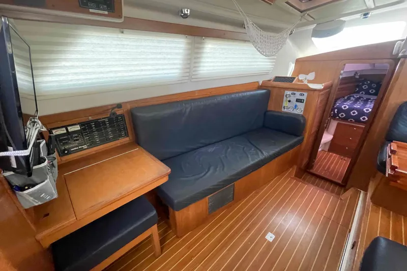 Slide: The Image of Interior of 2013 Catalina Morgan 440 yacht with wood finish and seating area. - 12