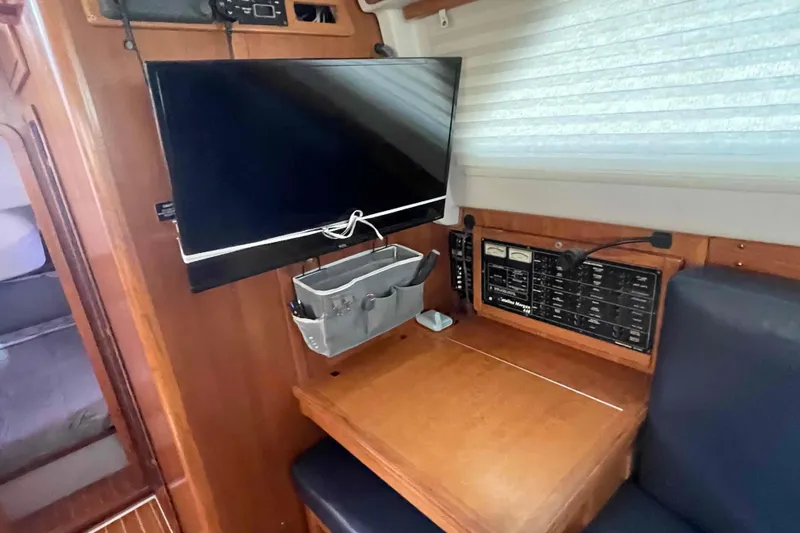 Slide: The Image of Navigation station in 2013 Catalina Morgan 440 yacht with TV and control panel. - 19