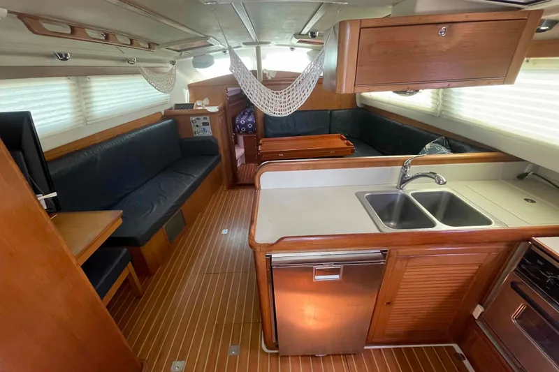 Slide: The Image of Interior of 2013 Catalina Morgan 440 yacht with kitchen and seating area. - 2