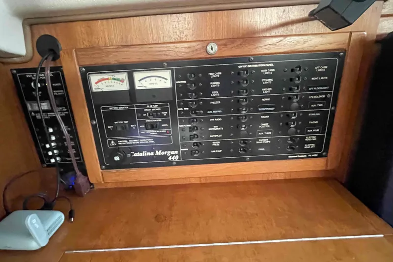 Slide: The Image of Electrical control panel of 2013 Catalina Morgan 440 yacht, featuring various switches and gauges. - 20