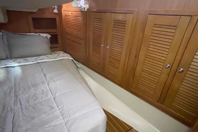 Slide: The Image of Cozy cabin interior of 2013 Catalina Morgan 440 yacht with wooden cabinets and bed. - 22