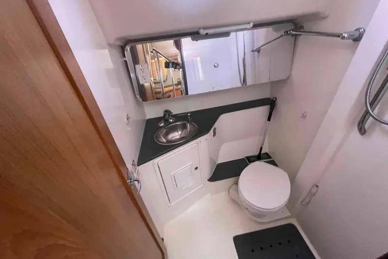Slide: The Image of Compact bathroom in 2013 Catalina Morgan 440 yacht, featuring sink, toilet, and mirror. - 24