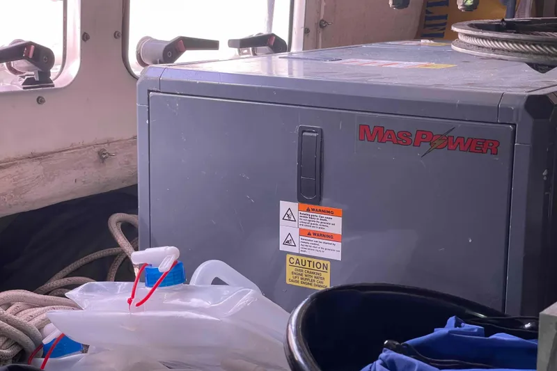 Slide: The Image of MasPower generator on Catalina Morgan 440 yacht, surrounded by ropes and equipment. - 27