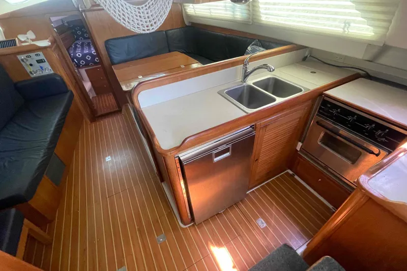 Slide: The Image of Interior of 2013 Catalina Morgan 440 yacht with kitchen and seating area. - 33