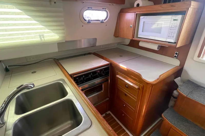 Slide: The Image of Compact kitchen in 2013 Catalina Morgan 440 yacht with sink, stove, and microwave. - 34