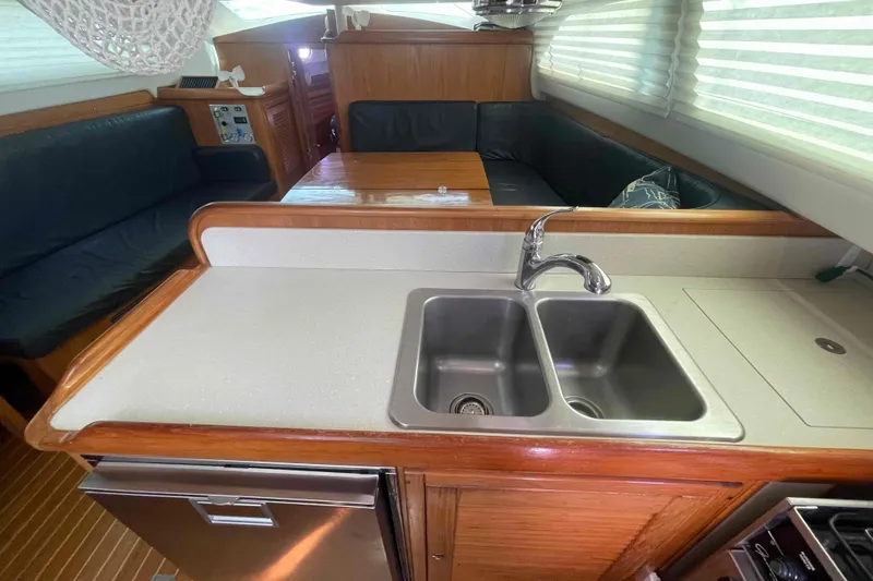 Slide: The Image of Interior of 2013 Catalina Morgan 440 yacht with kitchen sink and seating area. - 37