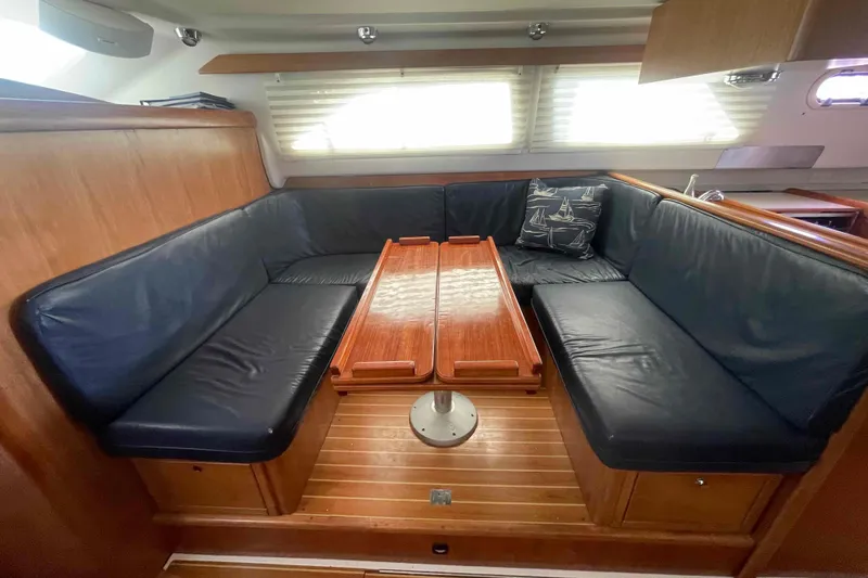 Slide: The Image of Interior of 2013 Catalina Morgan 440 yacht with leather seating and wooden table. - 4