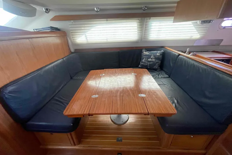 Slide: The Image of Interior of 2013 Catalina Morgan 440 yacht with wooden table and cushioned seating. - 5