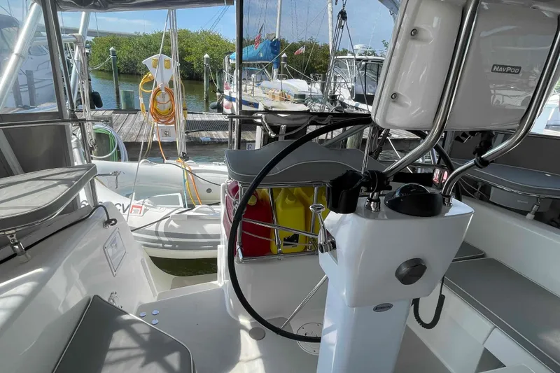 Slide: The Image of Cockpit view of 2013 Catalina Morgan 440 sailboat, featuring steering wheel and docked surroundings. - 50