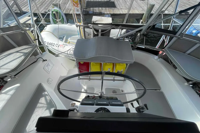 Slide: The Image of Cockpit of 2013 Catalina Morgan 440 sailboat with steering wheel and dock view. - 51