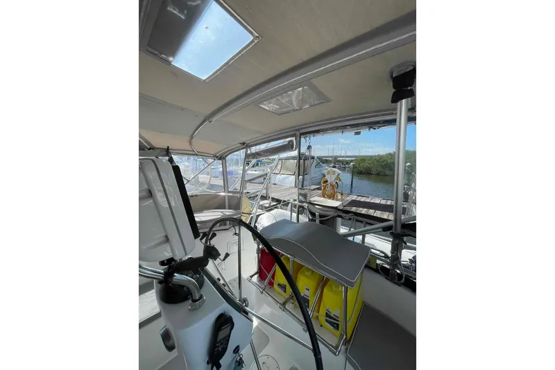 Slide: The Image of Interior view of 2013 Catalina Morgan 440 sailboat cockpit with steering wheel and seating. - 52