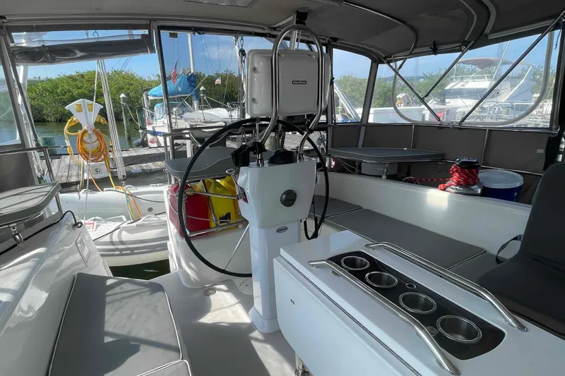 Slide: The Image of Interior view of 2013 Catalina Morgan 440 sailboat cockpit with steering wheel and seating. - 57