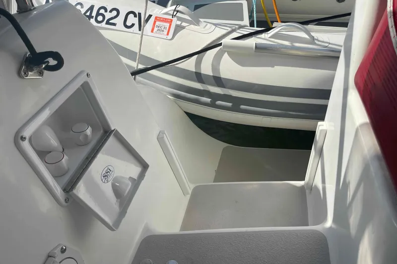 Slide: The Image of Interior view of a 2013 Catalina Morgan 440 boat, showcasing seating and storage compartments. - 62