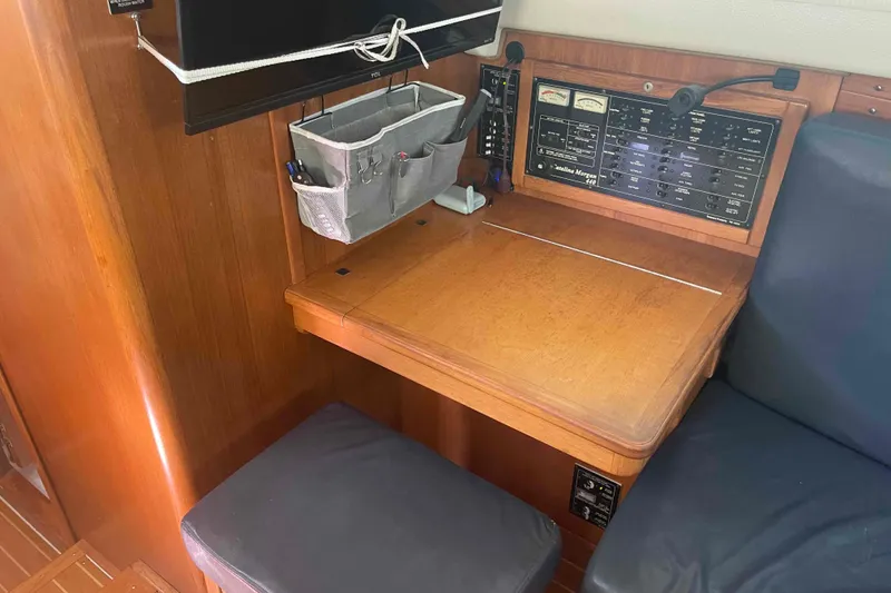 Slide: The Image of Navigation station inside 2013 Catalina Morgan 440 yacht with control panel and storage. - 65