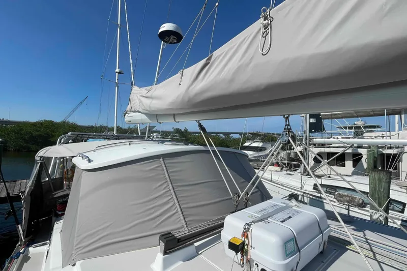 Slide: The Image of 2013 Catalina Morgan 440 sailboat docked, featuring sails and rigging under clear blue sky. - 73
