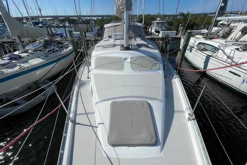 Slide: The Image of 2013 Catalina Morgan 440 sailboat docked among other vessels in a marina. - 78