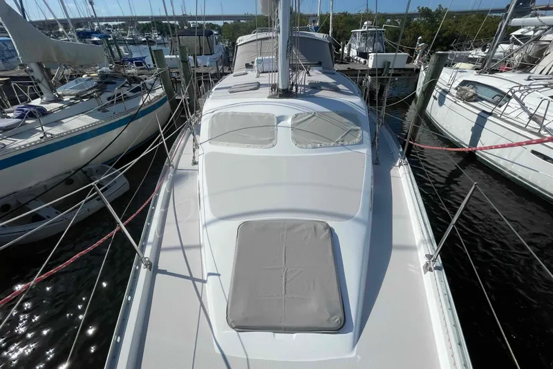 Slide: The Image of 2013 Catalina Morgan 440 sailboat docked at marina, surrounded by other vessels. - 79