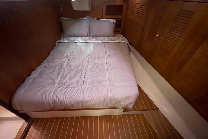 Slide: The Image of Cozy cabin bedroom in 2013 Catalina Morgan 440 yacht with wooden accents and comfortable bedding. - 8