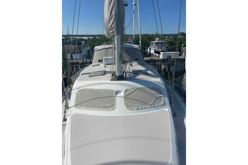 Slide: The Image of 2013 Catalina Morgan 440 sailboat docked, showcasing deck and rigging. - 80
