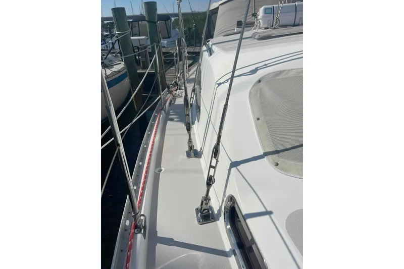 Slide: The Image of 2013 Catalina Morgan 440 sailboat deck with rigging and dock view. - 81